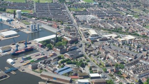 Aerial view of Goole showing the docks and houses on roads near the water 