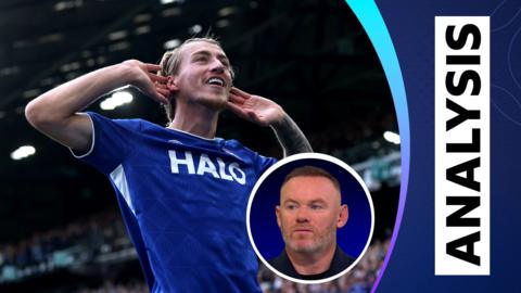Ipswich's Jack Clarke celebrates by cupping his ears to the crowd, as Wayne Rooney talks on Match of the Day