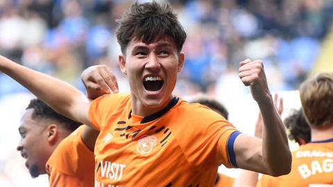 Rubin Colwill raises his fist to celebrate scoring for Cardiff
