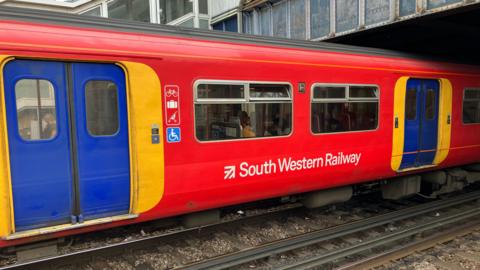 A SWR train at Clapham Junction station.