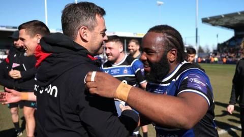 Beno Obano of Bath celebrates with head of rugby, Johann van Graan after their victory during the Premiership Rugby Cup Final between Exeter Chiefs and Bath at Sandy Park 