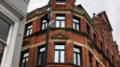 Image shows a speaker on a lamppost, which plays classical music to deter youths in Liverpool
