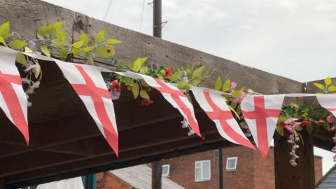 England flags fly on bunting in a pub garden