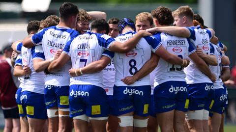 Bath players in a huddle during their match against Saracens