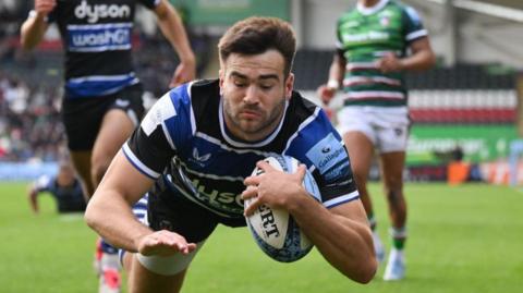 Will Muir dives over the line to score a try for Bath against Leicester