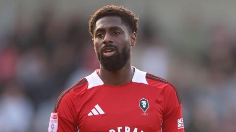 Hakeeb Adelakun standing on the pitch while playing for Salford last season