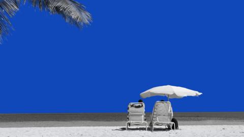 Two loungers and an umbrella on a beautiful sandy beach
