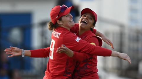 England players Nat Sciver-Brunt (left) and Sophia Dunkley (right) celebrate a wicket against West Indies