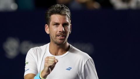 Cameron Norrie raises a clenched fist