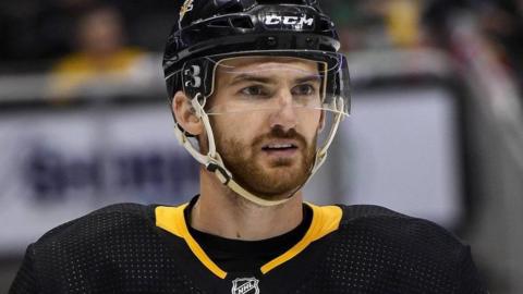 Adam Johnson in ice hockey kit looking into the distance