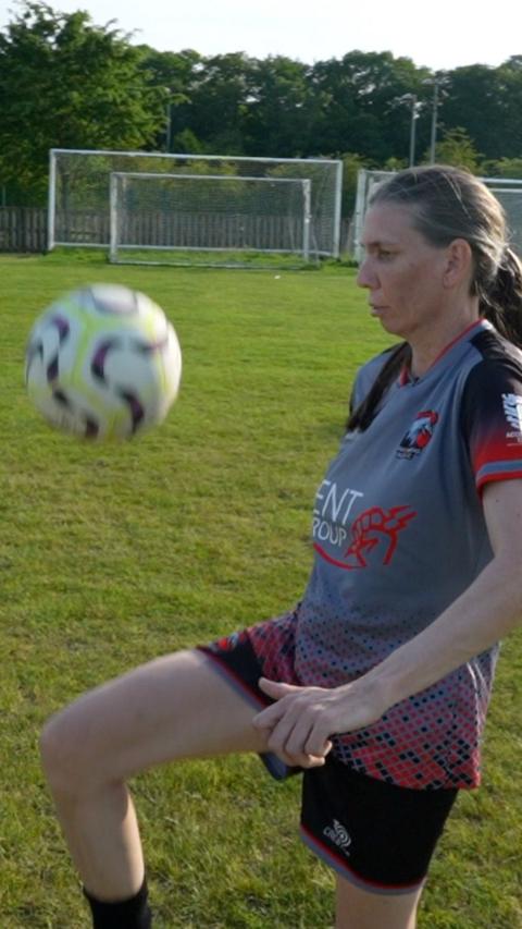 Woman doing keepy-uppies with a football