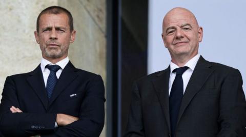  Uefa president Aleksander Ceferin and Fifa boss Gianni Infantino watch a football match from the stands