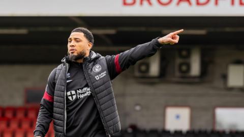 Colin Kazim-Richards points the way for his players at his first training session with Crawley Town