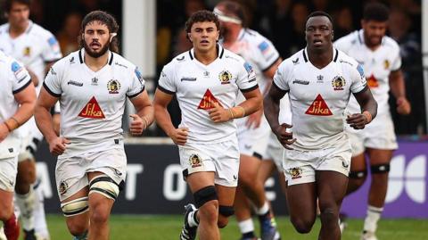 Exeter Chiefs players run on the pitch