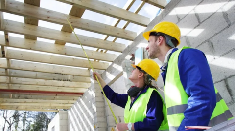 Man and woman inside a house being built