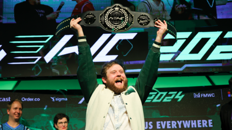 A person holding up the Microsoft Excel world championship belt
