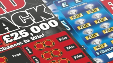 A close-up of several lottey scratch cards.