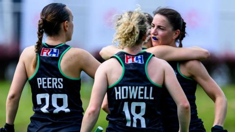 Beth Peers and Isabelle Howell congratulate Wales scorer Elizabeth Bingham