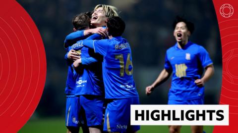Kyogo Furuhashi hugs fellow Birmingham City players as they celebrate in blue kit