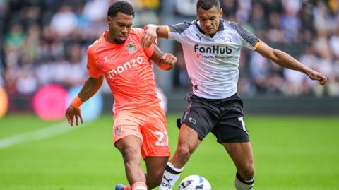 Milan van Ewijk of Coventry City and Kayden Jackson of Derby County