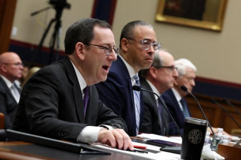 Northwestern University president Michael Schill speaks in front of a microphone at a congressional hearing