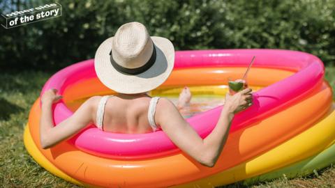 Woman in paddling pool in the sun