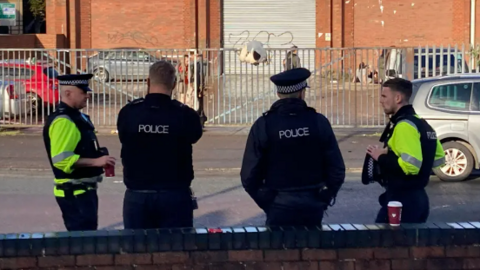 Police outside the Wickes building where the illegal rave was held