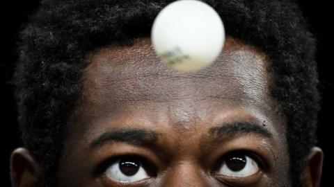 An image of Senegal's Ibrahima Diaw as he serves the ball to his opponent at the Paris Olympics.