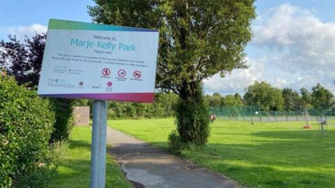 A sign in a park which reads 'Marje Kelly Park' 