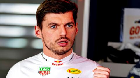 Max Verstappen wearing a white fireproof top in the Red Bull garage at the Japanese Grand Prix