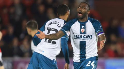 Morecambe captain Yann Songo'o celebrates his goal against Fleetwood Town.