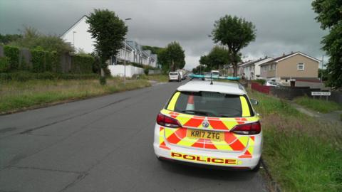 A police car parked on a residential street