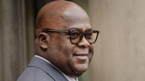 President Felix Tshisekedi in a grey suit and glasses