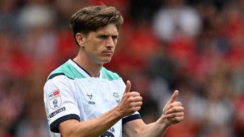 Adam Reach of Lincoln City celebrates after scoring the team's first goal