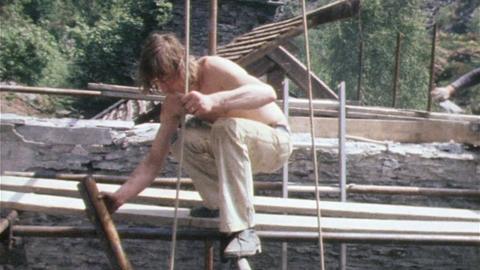 A man working on an uncompleted building.