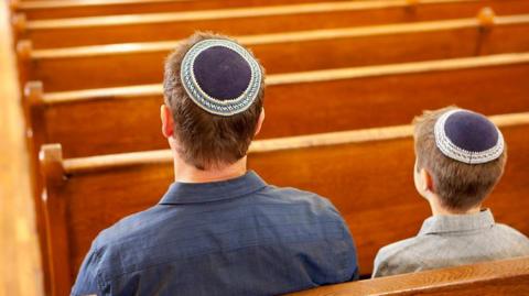 Two people in a synagogue