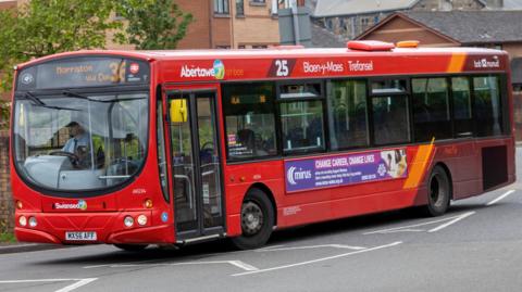A red bus on a road