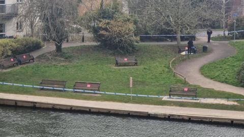 An grassy area next to the River Thames at Chertsey cordoned off with police tape