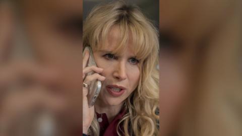 Lucy Punch as Amanda on the phone to someone, looking concerned.