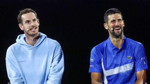 Andy Murray and Novak Djokovic laugh during a charity match at the Australian Open in January 2025