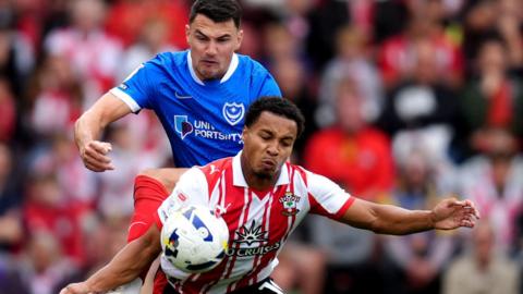 Regan Poole battles with Southampton striker Cameron Archer