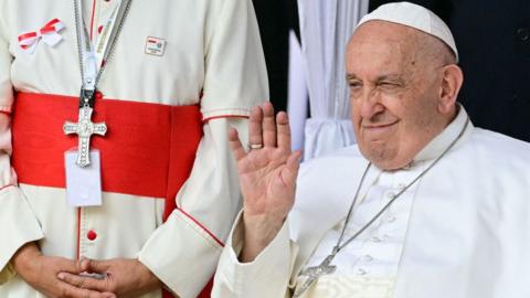 Pope Francis waves during an interreligious meeting with religious leaders at the Istiqlal Mosque in Jakarta on September 5, 2024.