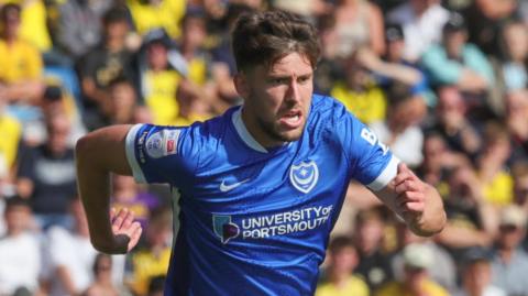 Callum Lang of Portsmouth chases the ball 