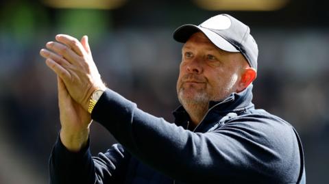 Bromley boss Andy Woodman applauds the supporters