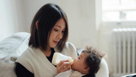 Mum feeding baby from a bottle 