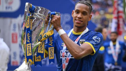 Alistair Smith holds the League Two play-off final winners' trophy