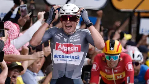Jasper Philipsen celebrates winning stage one of the 2025 Tour de France