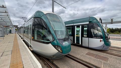 Two trams at the stop.