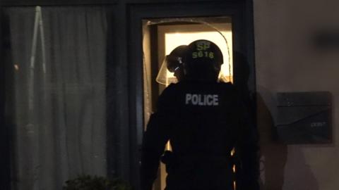 police officer entering house