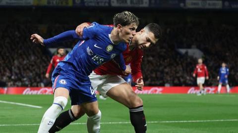 Chelsea's Alejandro Garnacho tussles with former Manchester United team-mate Diogo Dalot at Stamford Bridge
